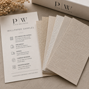 Neutral textured wallpaper samples displayed beside a Plain Wallpaper sample card and branded packaging.