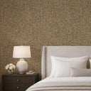 Warm living room with mica beige textured wallpaper, neutral sofa, gold pendant lights, and round coffee table.