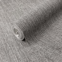 Dense woven raffia wallpaper in dark charcoal with salt-and-pepper tones, ideal for creating a tactile accent wall in a modern bedroom or office, emphasizing organic texture and quiet sophistication.