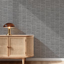 Gray grasscloth wallpaper emphasizing its deeply embossed texture, suitable for creating layered complexity in hallways and bathrooms. Offers a warm, woven look with architectural appeal.
