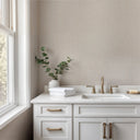 Tweed-inspired light beige wallpaper with a compact textile weave and warm neutral flecking that suggest woven yarn. The tactile, matte grain adds understated fabric character to full rooms or accent walls. Requires adhesive application.
