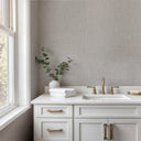 Light gray tweed texture wallpaper with a compact stippled weave of tiny intersecting marks forming a soft granular field. The cool pale gray palette and matte micro-relief create an understated textile backdrop for bedrooms, offices and hospitality spaces. Adhesive required.