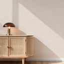 Limewash-inspired wallpaper in pale beige featuring faint horizontal striations, adding warmth and subtle texture to minimalist spaces.