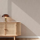 Vertical line texture wallpaper in soft beige features fine ribbing and occasional horizontal threads. Its matte finish and gentle vertical rhythm enhance walls, ideal for minimalist or modern interiors. Adhesive required, perfect for spaces seeking architectural elegance.