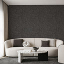 Close-up of dark gray wallpaper with dense mica texture, providing a matte base with subtle metallic shimmer for modern interiors.