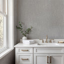 Woven gray raffia wallpaper with lighter highlights on the raised strands and a tactile, basket-like relief in the embossed weave. A strong natural texture with architectural presence at normal viewing distance. Requires adhesive application.
