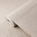 Light beige tweed texture wallpaper with a dense, pebble-like weave of tiny interlocking loops and flecks. Pale sand tones with darker specks create fabric-driven depth in a matte finish, grounding living areas, corridors and hospitality interiors. Adhesive required.