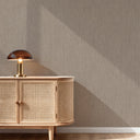 Close-up of brown vertical lines wallpaper showing its linear texture and faint metallic highlights. Ideal for hallways or modern spaces needing vertical emphasis and a sophisticated, textural surface. Made in the USA with high-quality materials.