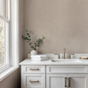 Warm dark beige wallpaper with a linen-plaster texture of fine, consistent grain and soft irregularities that suggest troweled natural fiber. The small-scale matte pattern conceals minor wall imperfections while adding quiet tactility. Requires adhesive application.