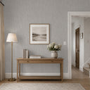 Gray raffia texture wallpaper with a medium-scale woven grid and warm gray undertones across the embossed strands. The handcrafted basket weave adds organic character to modern and coastal interiors. Wallpaper requires adhesive.