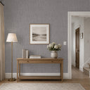 Dark gray raffia wallpaper with pronounced striations, offering a fibrous finish that captures light, suitable for spaces needing a neutral yet textured backdrop.