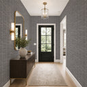 Warm gray grasscloth-inspired wallpaper with stacked linear weave, ideal for accent walls in living areas seeking a natural, handwoven texture.