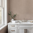 A warm taupe wallpaper with a plaster-inflected linen texture and subtle irregularities. Suitable for transitional spaces or cozy living rooms, offering a tactile, matte finish. The eco-friendly material is strippable and requires wallpaper adhesive.