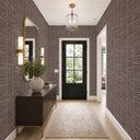 Detailed view of brown grasscloth wallpaper with visible slubs and a slightly coarse surface texture. Its artisanal character suits dining rooms or feature walls, offering a natural, crafted aesthetic.