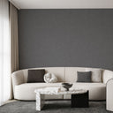 Dark gray limewash wallpaper with aged plaster effect, suitable for adding depth and texture to industrial or rustic-contemporary rooms.