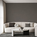 Charcoal gray limewash wallpaper with subtle crosshatch texture, providing a layered surface character suitable for lofts or urban-inspired interiors.