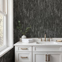 Charcoal wallpaper with broad vertical bands and reflective patina, perfect for media rooms seeking a bold, atmospheric backdrop.