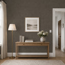 Brown shiny limewash wallpaper with irregular brush textures and a lived-in, artisanal character. Warm brown-ash tones and gentle luster create a dramatic yet organic backdrop for modern interiors. Wallpaper requires adhesive.
