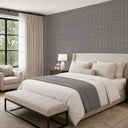 Taupe-gray grasscloth wallpaper with pale highlights tracing individual fiber paths, perfect for adding a sense of artisanal construction to hallways and laundries.