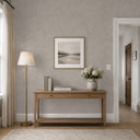 Beige shiny limewash texture wallpaper with soft pearlescent highlights over a mottled taupe base, showing irregular brush and scrape marks that shimmer gently at an angle. Medium texture with smooth and raised areas adds movement and subtle luminosity to accent walls in modern-luxe and transitional rooms. Adhesive application required.