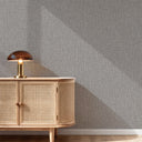 Tweed wall covering with a speckled effect in dark gray tones, perfect for home decor projects seeking a subtle, textile-inspired finish.