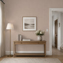 A soft, earthy field in taupe linen plaster texture wallpaper with subtle dimpled surface. Ideal for cozy living areas or transitional spaces, offering warmth and tactile interest. This eco-friendly, strippable wallpaper requires adhesive for application.