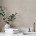 Light beige wallpaper with a tweed texture, emphasizing a dense, pebble-like weave. The tiny interlocking loops and matte finish offer a fabric-driven surface, perfect for creating a grounded atmosphere in living areas or corridors.