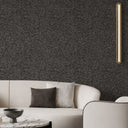 Mica-speckled wallpaper in dark gray, featuring metallic highlights for a dramatic and tactile surface in hospitality zones.