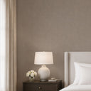Brown linen plaster wallpaper featuring a fine granular surface and subtle woven texture, offering soft shadowing without strong highlights. Ideal for creating an understated, durable backdrop in residential or office interiors.