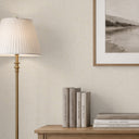 Creamy off-white linen wallpaper with shadowed thread lines, creating depth and warmth in hospitality suites or bedrooms.