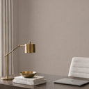 Vertical taupe wallpaper with a subtle striated field, emphasizing height and structure in contemporary spaces.