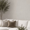 Light gray raffia texture wallpaper mimicking natural fiber strands in a loose, hand-woven weave. Elongated, slightly irregular threads and visible grain give the matte surface organic relief, adding earthy warmth to sunrooms, coastal schemes and casual modern interiors. Adhesive required.