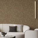 Mottled taupe wallpaper with darker speckling and mica-like clusters, perfect for adding visual weight to restaurant booths or living spaces.