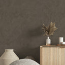 Close-up of brown shiny limewash wallpaper showing its brushed textures and tonal shifts. Ideal for adding a dramatic, artisanal feel to hospitality settings. Made in the USA with high-quality materials for easy application.