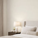 Understated limewash wallpaper with irregular brushed strokes in off-white and cream, perfect for living spaces or gallery walls. The wallpaper's subtle texture and matte finish create a calm, tactile backdrop. Traditional unpasted wallpaper, easy to apply for decorators and designers.