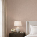 Taupe wallpaper with a plaster-inflected linen texture and pebble-like weave. Suitable for feature walls or cozy living rooms, providing a warm, earthy backdrop. The high-quality material is washable and requires wallpaper adhesive for a durable finish.