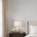 Soft, mid-gray linen plaster wallpaper with a textile-like finish, perfect for creating an understated, comforting texture in bedrooms and nurseries.