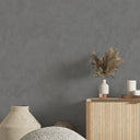 Close-up of gray shiny limewash wallpaper showcasing irregular, pearlescent highlights and matte recesses, suitable for upscale restaurant and gallery interiors.