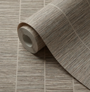 A roll of textured wallpaper with a horizontal pattern in warm taupe and beige tones, partially unrolled on a matching surface.