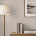 Greige linen wallpaper featuring a tight weave, providing a soft fabric-like backdrop for bedrooms or offices.