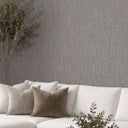 Organic raffia texture wallpaper in dark gray, providing a subtle tonal depth and tactile surface, ideal for quiet, natural character in bedrooms or offices.