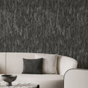 Dark charcoal wallpaper with undulating vertical bands, offering a dramatic yet subtle shimmer for media rooms or feature walls.