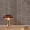 Close-up of brown grasscloth wallpaper showcasing its handwoven interpretation with visible slubs and thread-like streaks. Perfect for adding a crafted, natural aesthetic to study spaces or dining rooms. Made in the USA with high-quality materials.