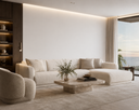 A modern living room featuring a large cream-colored sectional sofa, a matching curved armchair, a low stone coffee table, and a large window overlooking the ocean.